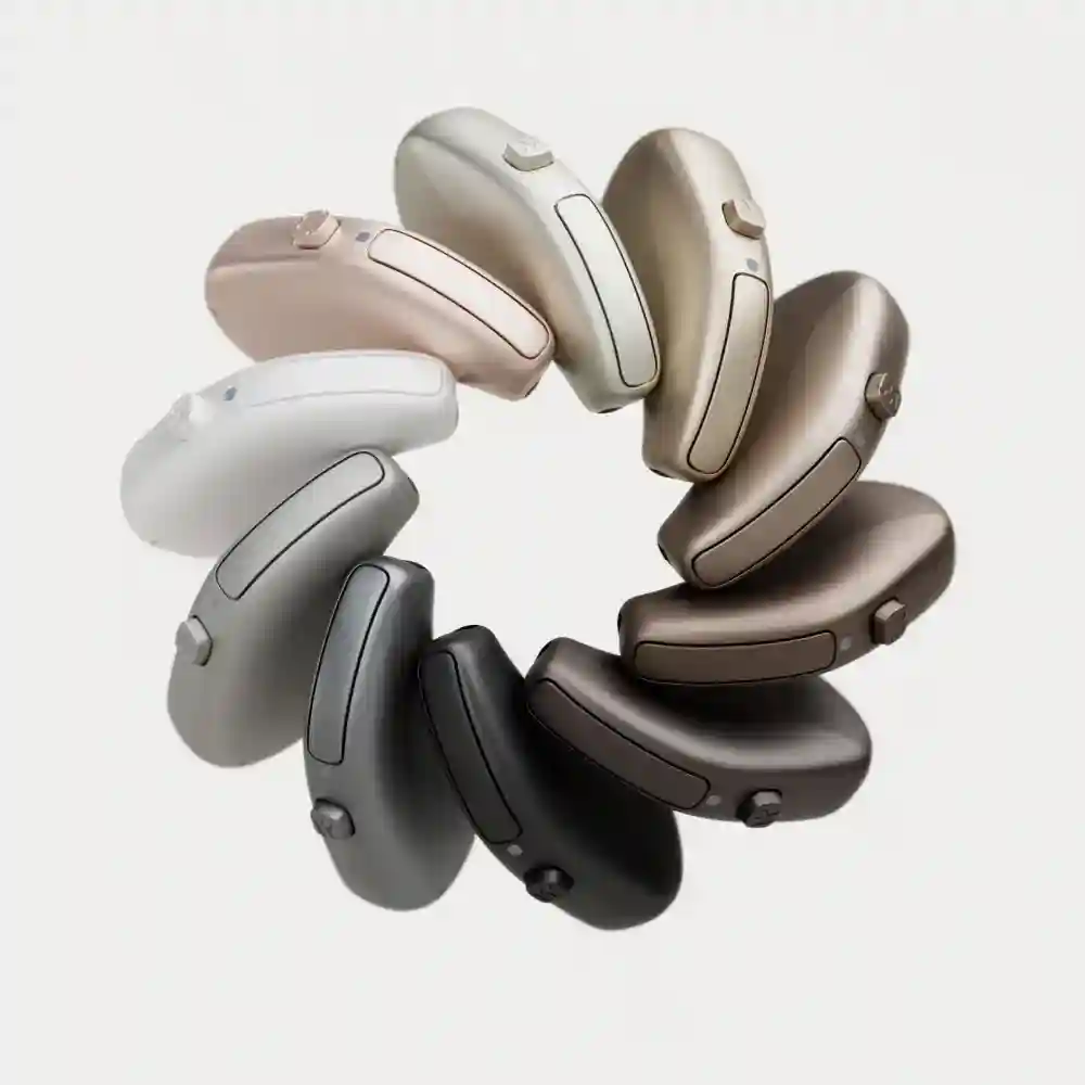 Aparelhos auditivos Oticon Intent miniRITE dispostos em círculo, mostrando a ampla gama de cores disponíveis